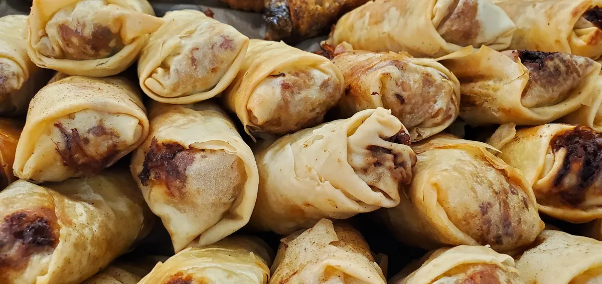 Pile of golden-brown fried spring rolls