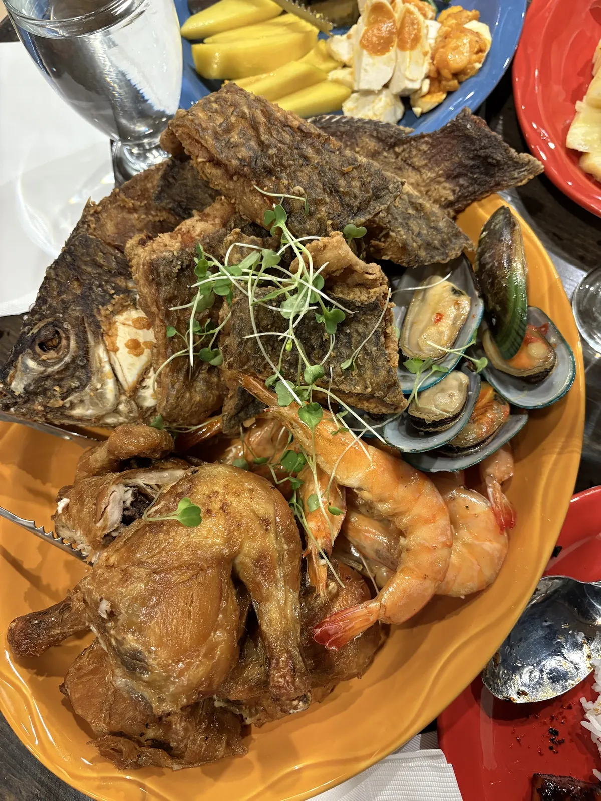 Large platter of fried fish, chicken, shrimp, and mussels